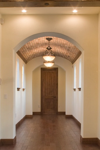 Brick veneer single barrel ceiling in a home designed and built by Orlando Custom Builder Jorge Ulibarri. This single barrel ceiling works well for hallways. 